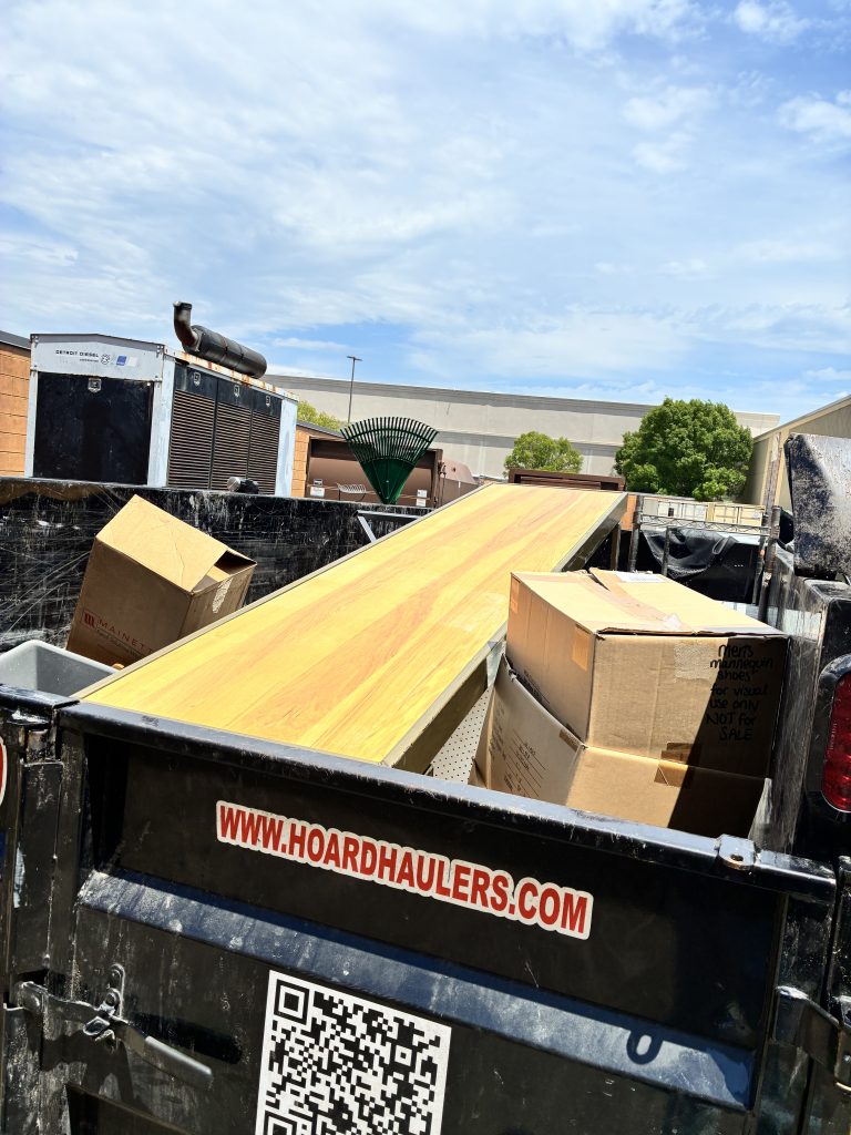 Lumber and construction debris loaded in a Hoard Haulers trailer