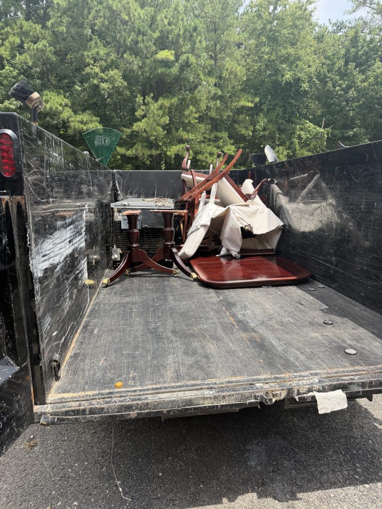 Dining table and chairs in a Hoard Haulers trailer headed for donation