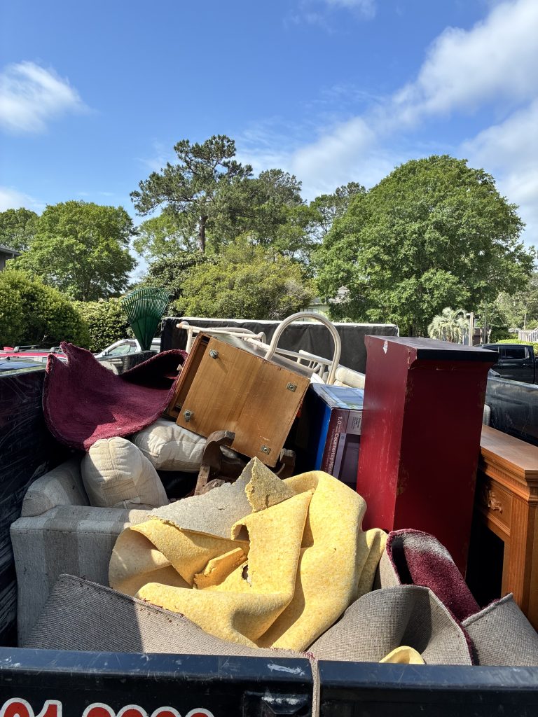 Couches and rugs loaded for furniture removal